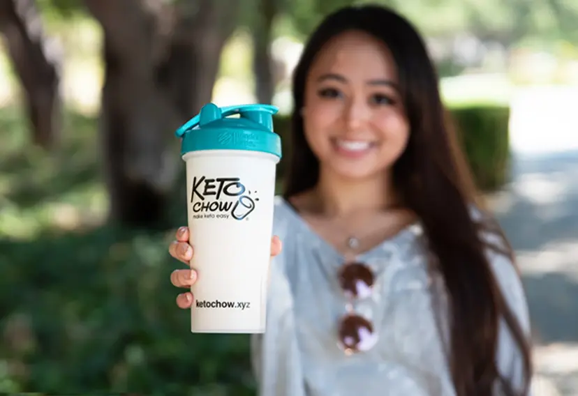 a woman holding bags of keto chow