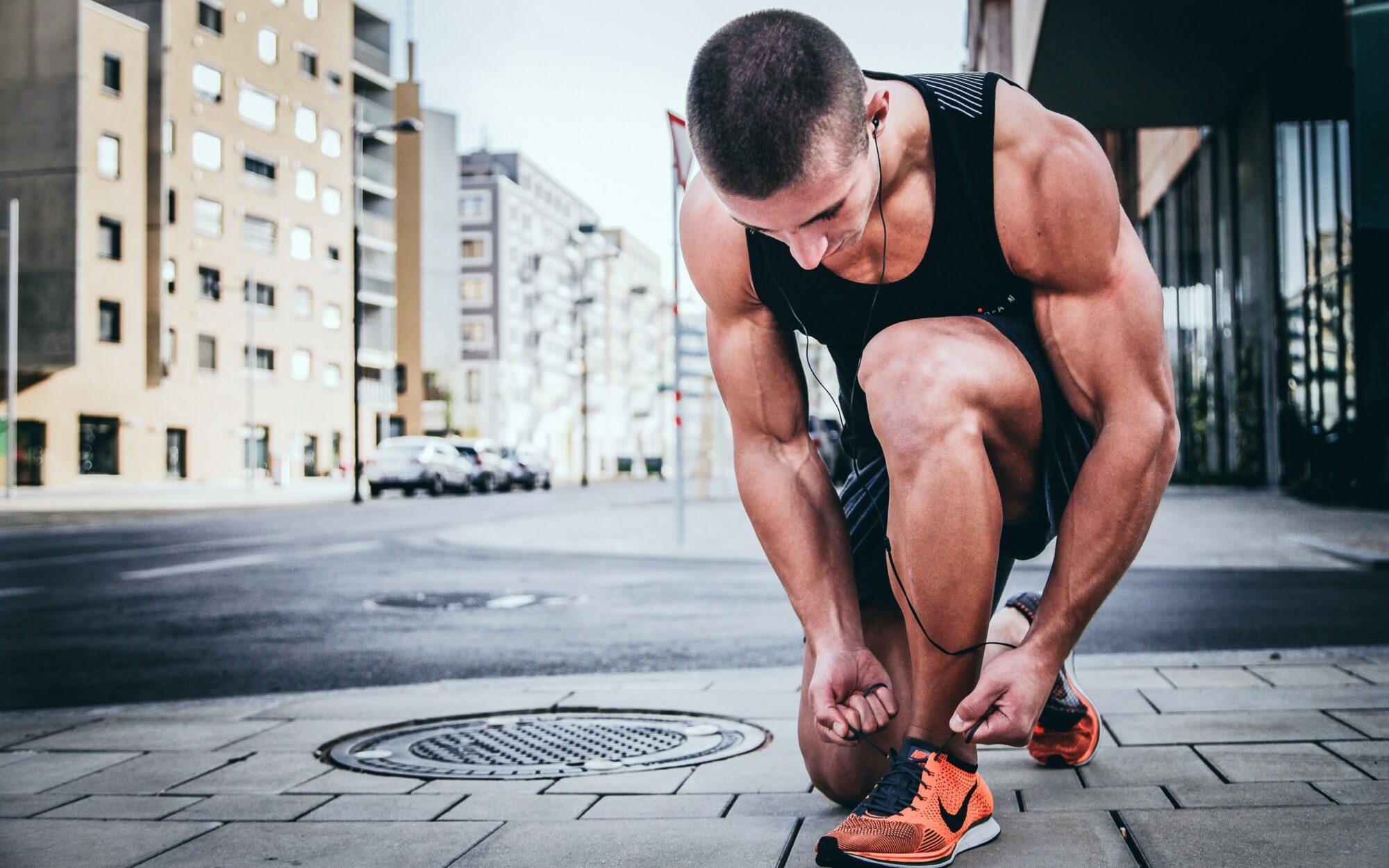 man tying shoes for workout