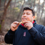 man eating chicken wing