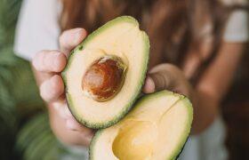 woman holding avocados