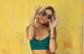 woman holding up sunglasses