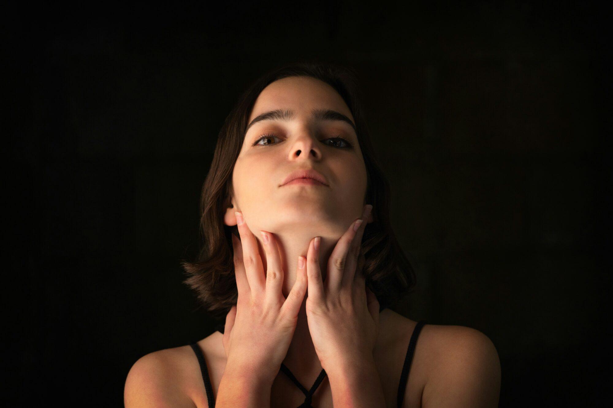 woman touching her neck